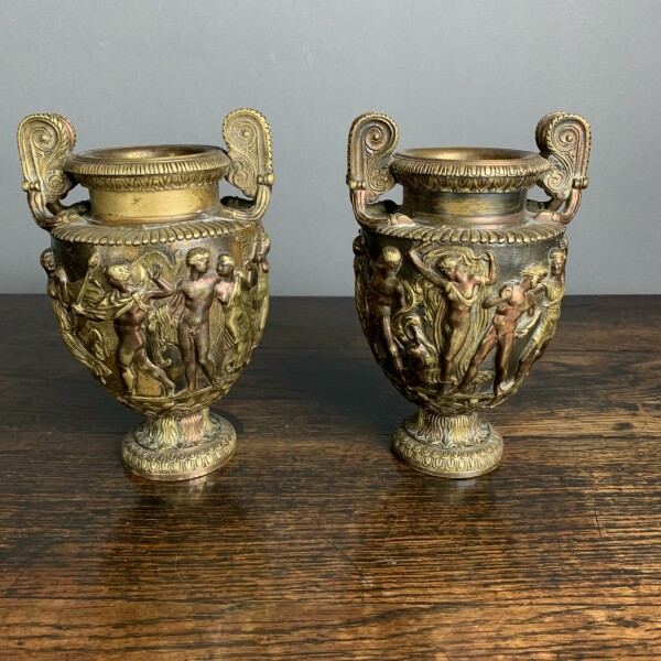 A pair of classical and decorated Gilt Urns Front