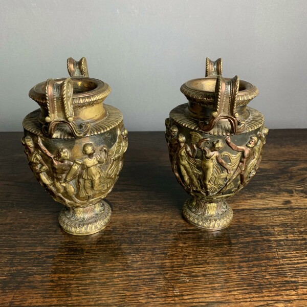 A pair of classical and decorated Gilt Urns Side