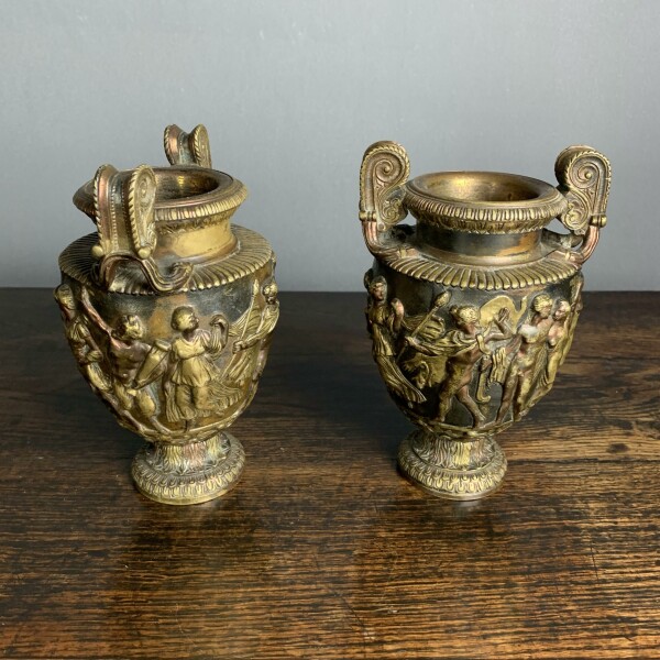 A pair of classical and decorated Gilt Urns Front Facing