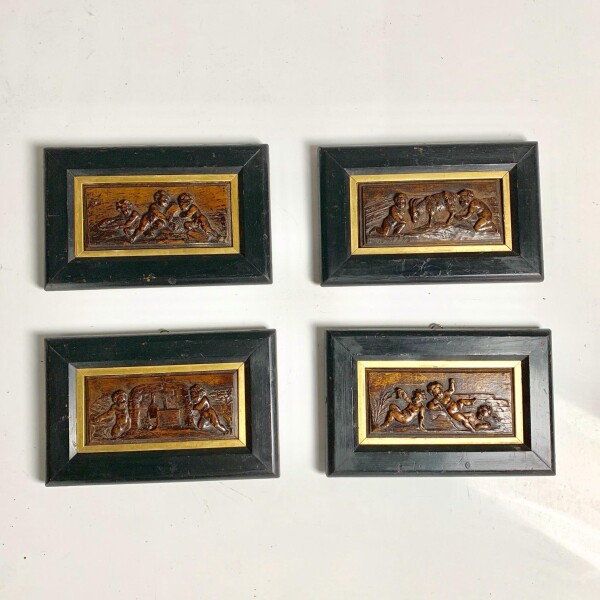 A Set of four continental walnut carved panels 17th century with Frame