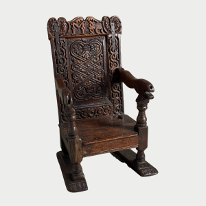 Small 17c oak childs chair very well carved and on later sledge feet
